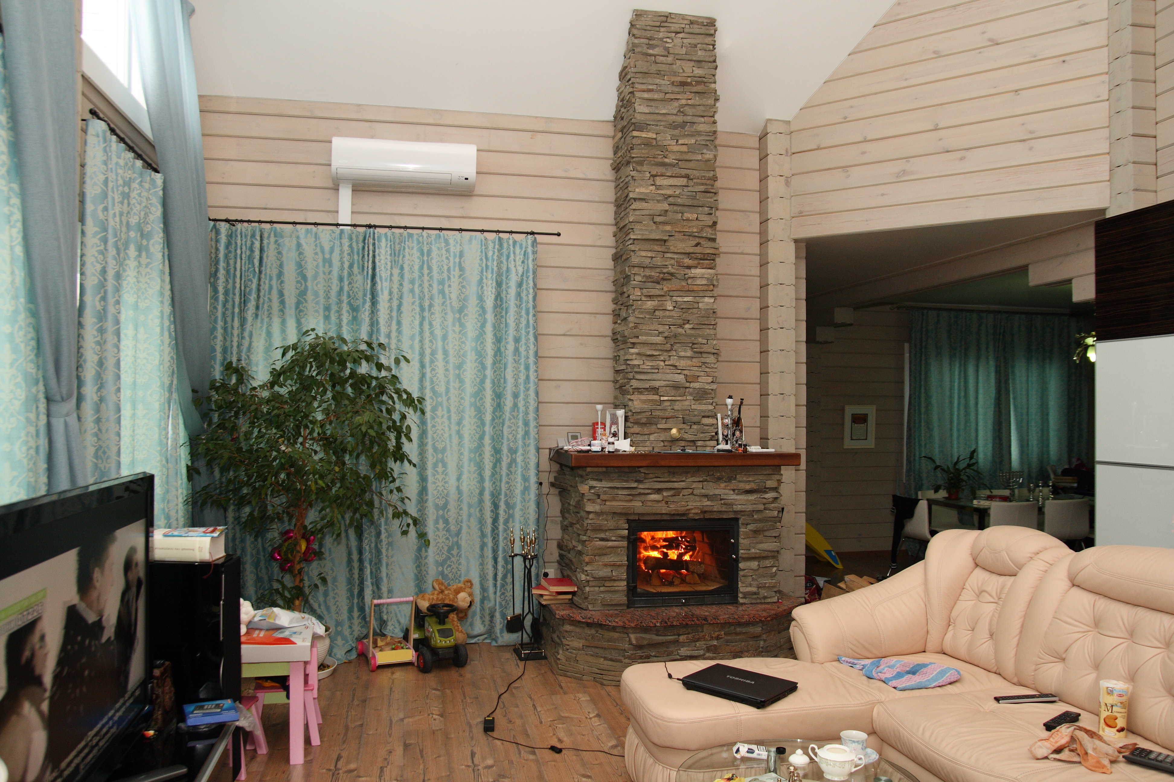 Дизайн гостиной с камином в деревянном доме из бруса